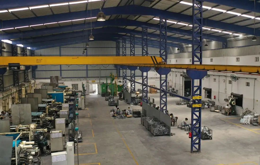 Workshop interior featuring machining equipment and overhead crane