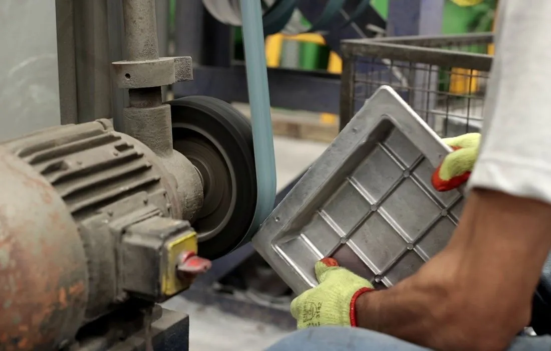 Die-cast part being ground and refined