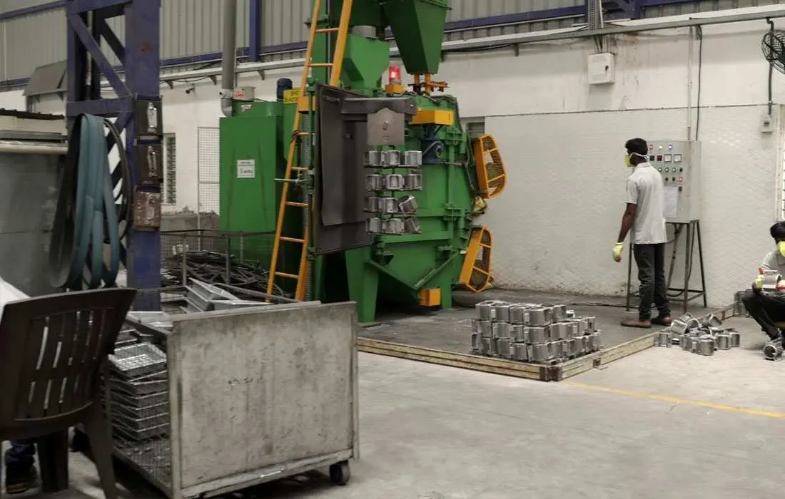 Die-casting press machine operating inside manufacturing facility