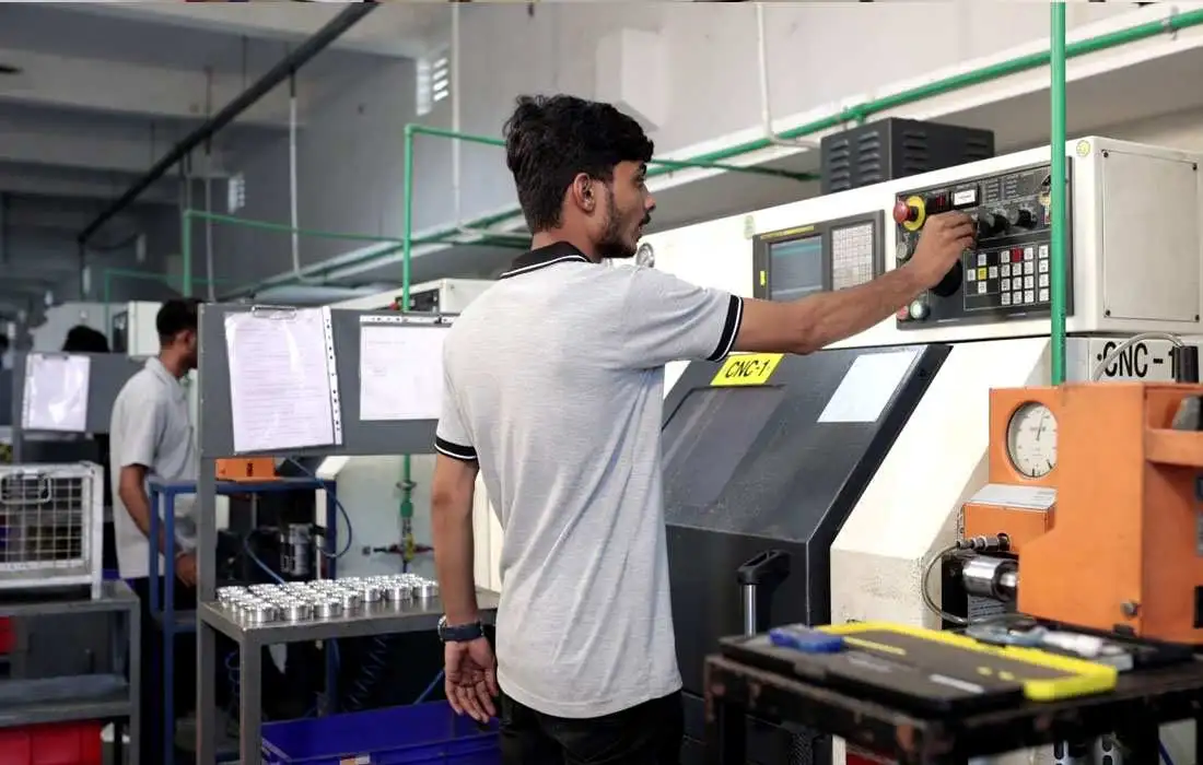Skilled technician adjusting CNC machine control panel
