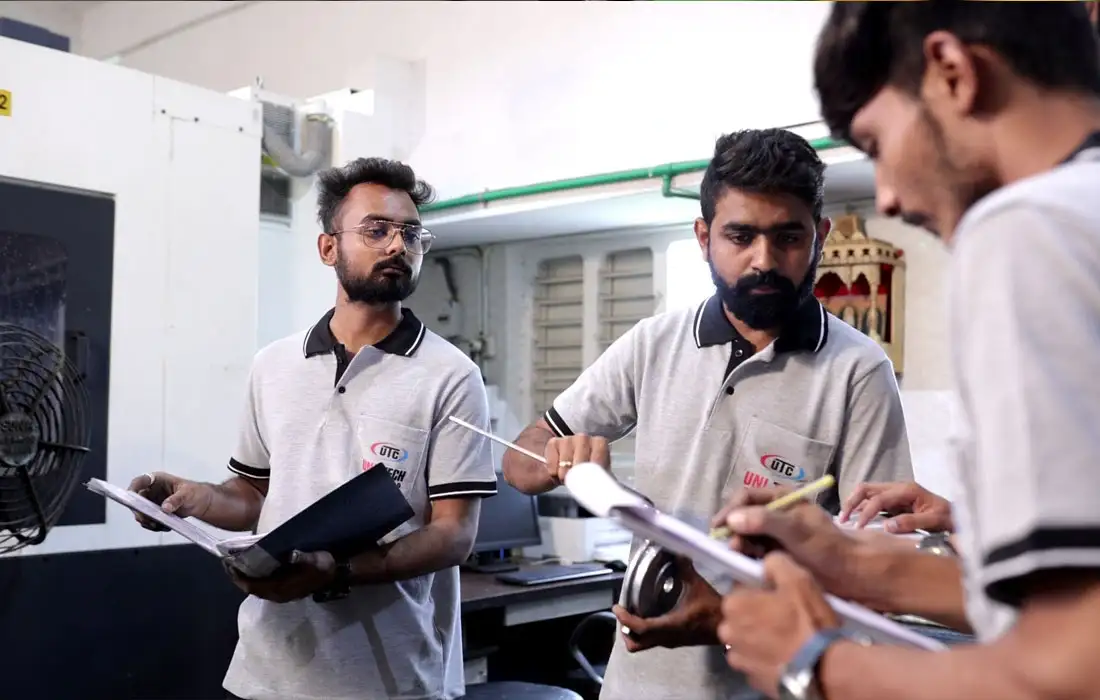 Engineering team inspecting machined metal component for accuracy and quality standards