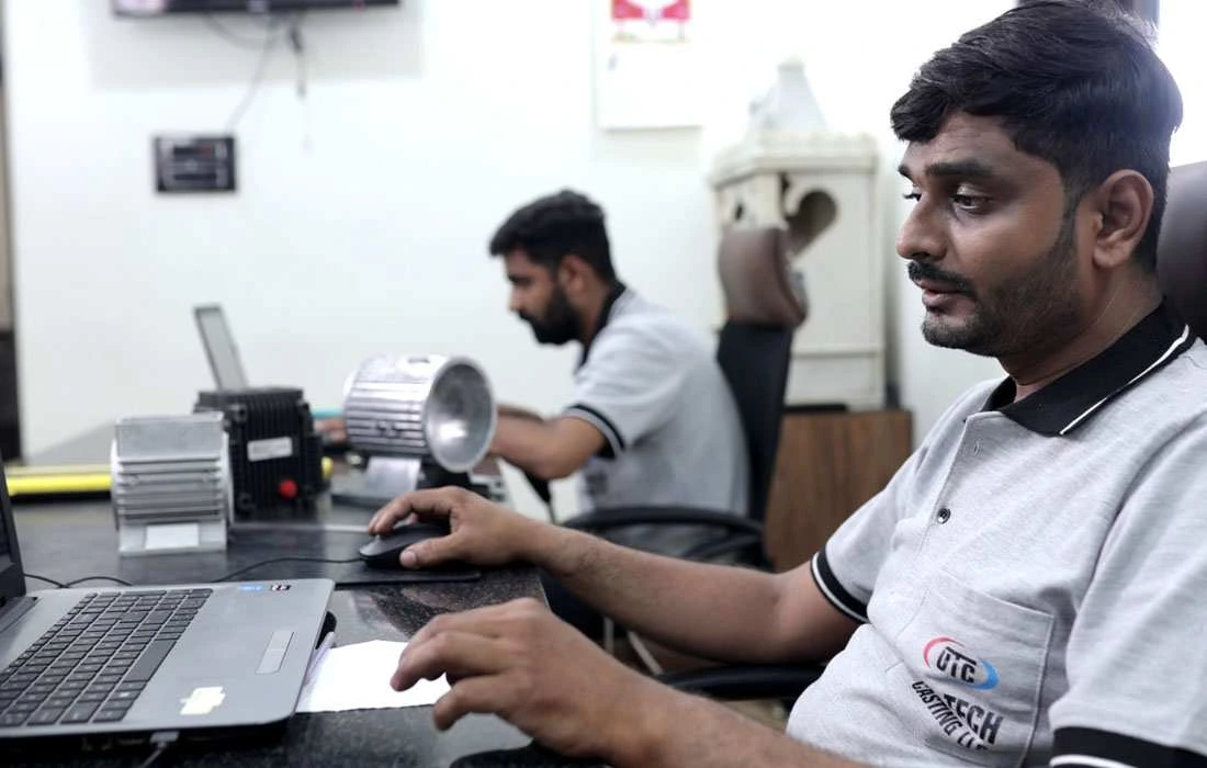 Production planning engineer analyzing manufacturing data on computer