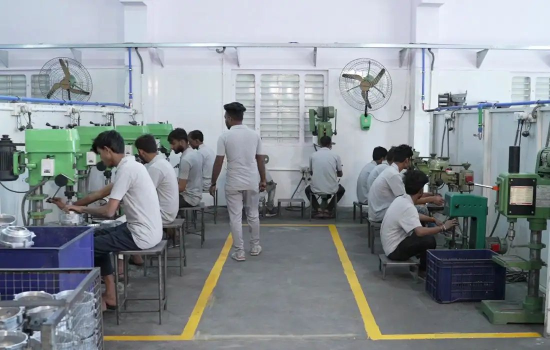 Manufacturing assembly with operators working on die-cast components