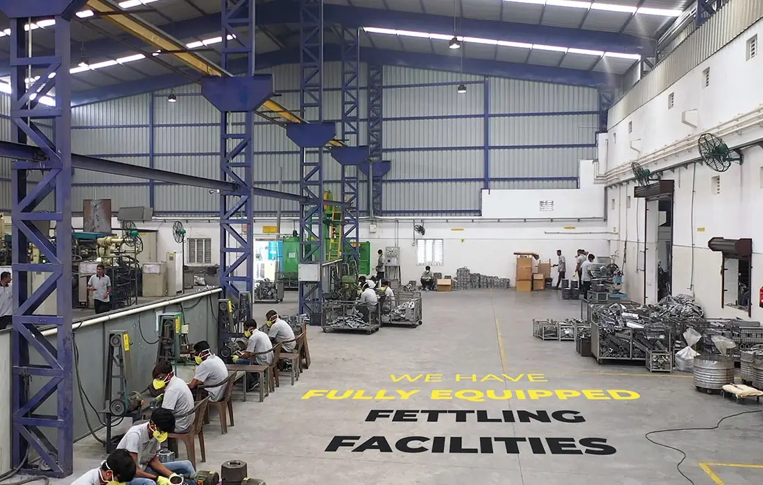 Fettling facility with workers trimming and finishing components