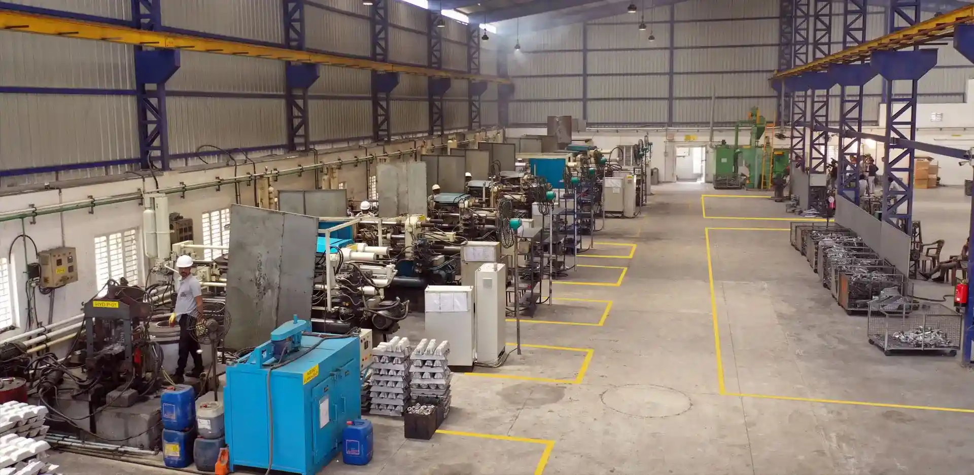 Die-casting manufacturing plant showing production machines and workers